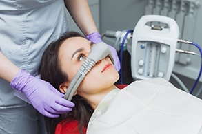 Dental assistant putting nasal mask in position