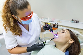 A sedated woman receiving dental treatment